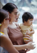 Wilcommen, No. 0045 Young Woman in Sunglasses Carries Baby and Bottle of Juice